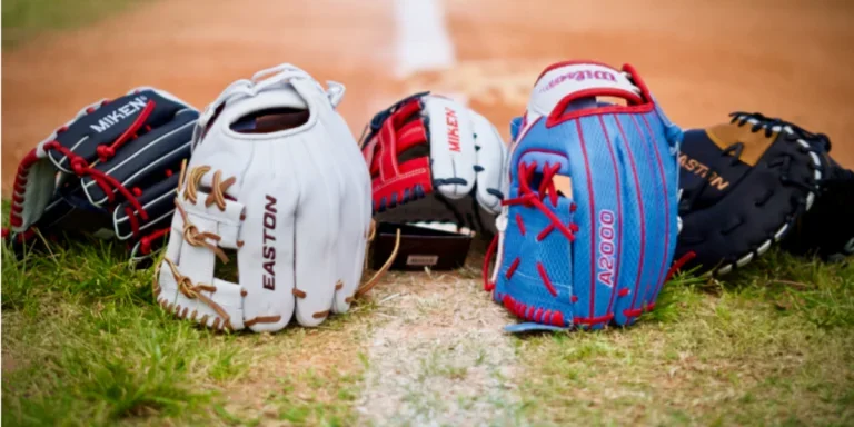Multiple softball mitts on a field