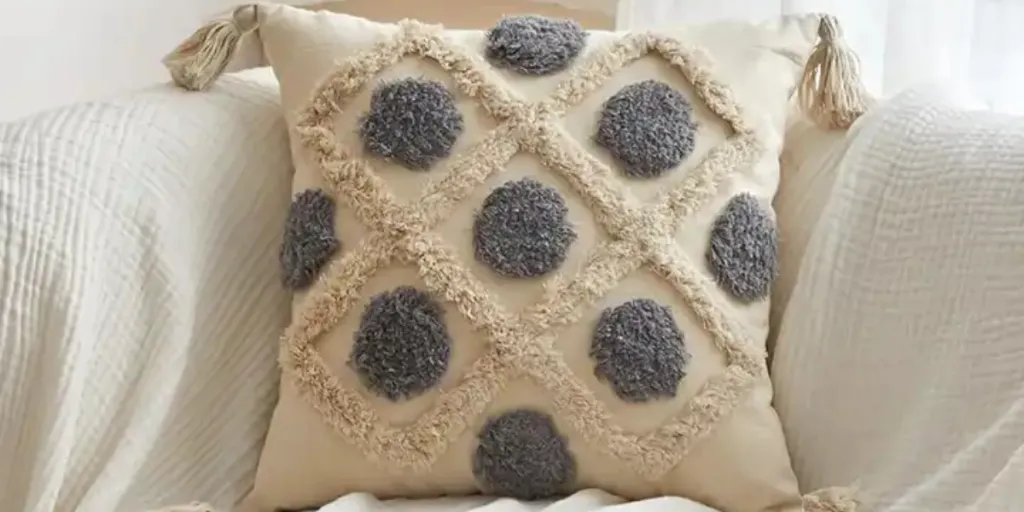 Natural fabric cushion cover in cream and gray color with contrasting textures