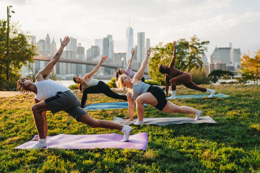Outdoor yoga class in park next to large city