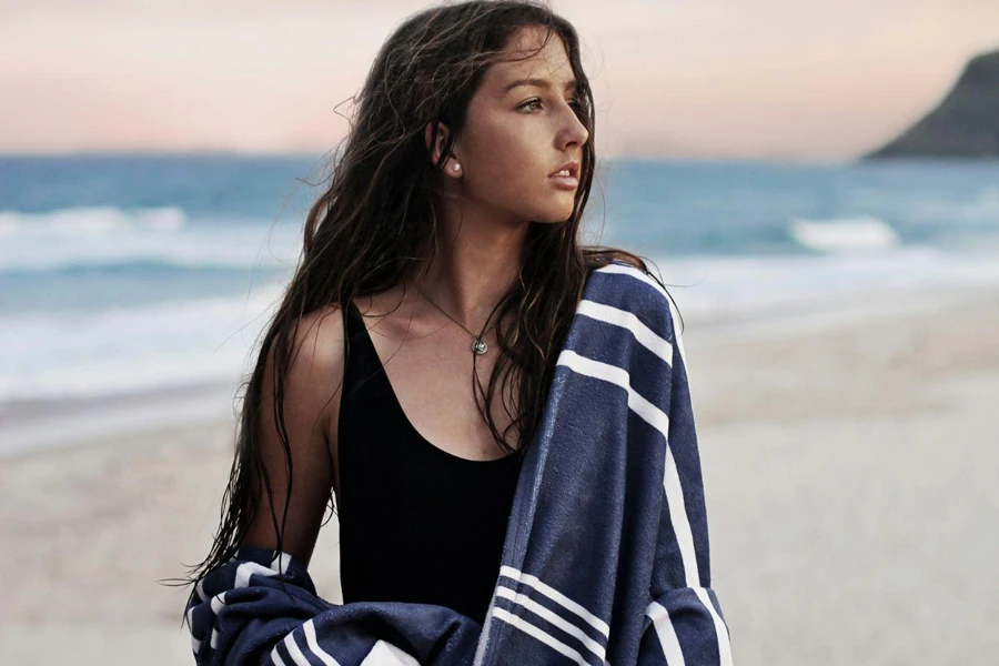 Oversized towel laying on sand