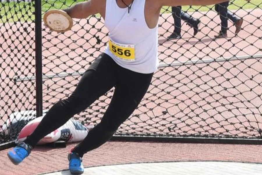 Person about to a discus disc on a field