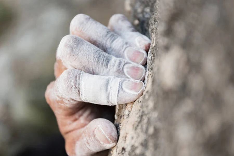 Person clapping hands while wearing powdered climbing chalk1