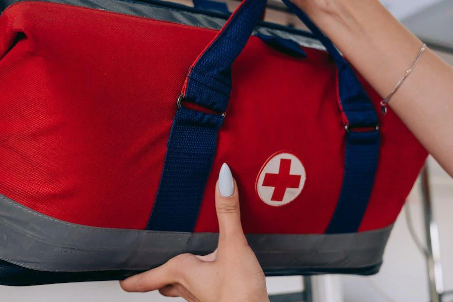 Person holding a large first aid kit