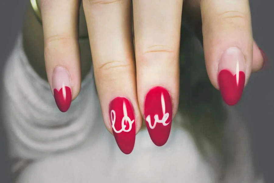 Person showcasing red polygel nails