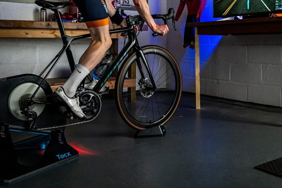 Person using a colorful bike trainer setup