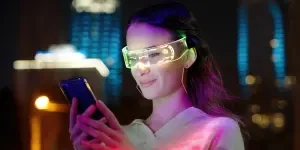 Person using smartphone and wearing AR glasses