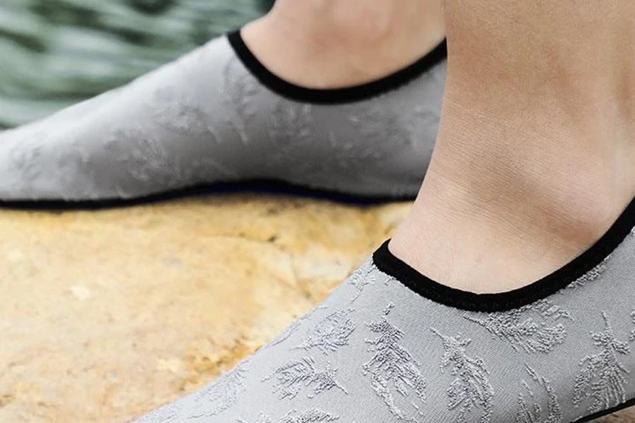 Person wearing a pair of gray water socks