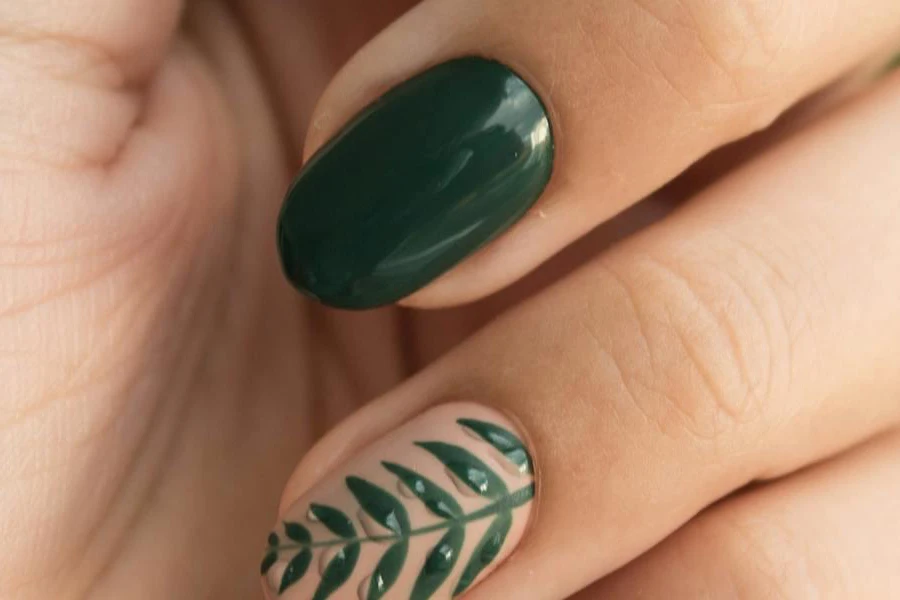 Person with green gel nail polish and nail art