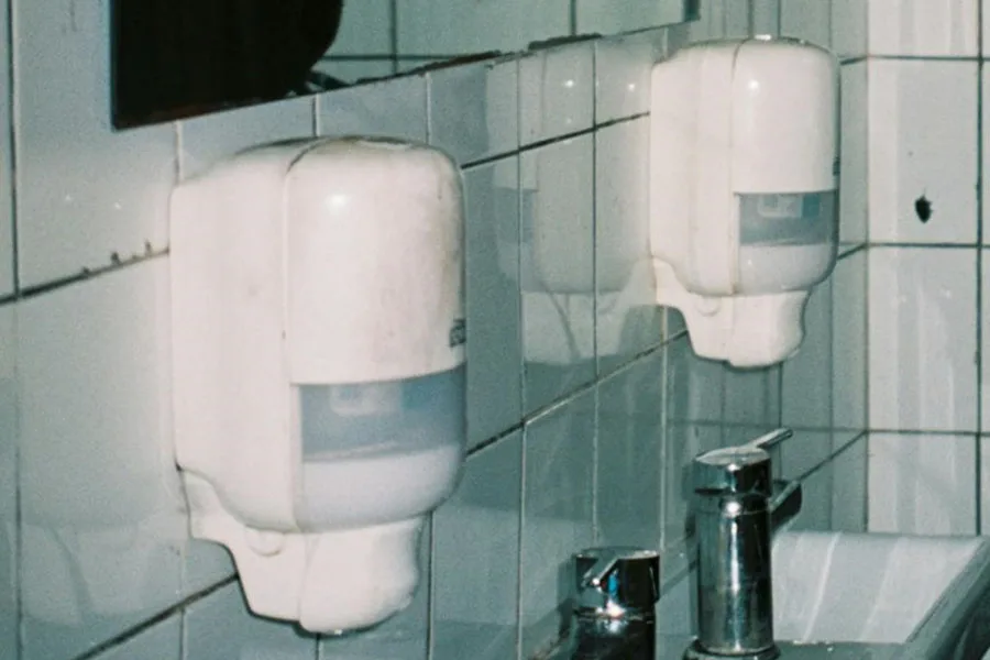Public bathroom with wall mount touchless soap dispensers
