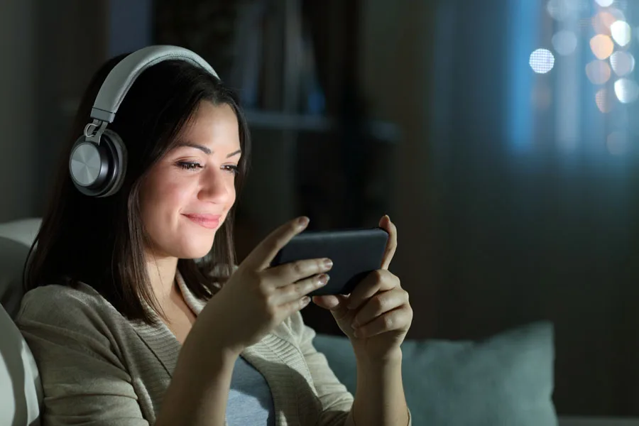 Relaxed woman watching video at night