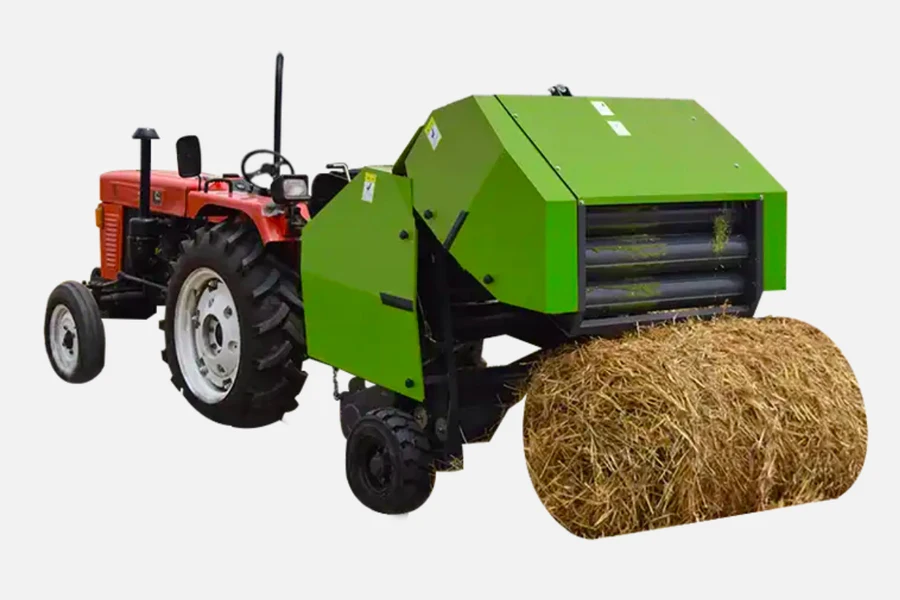 Round hay baler towed behind a tractor