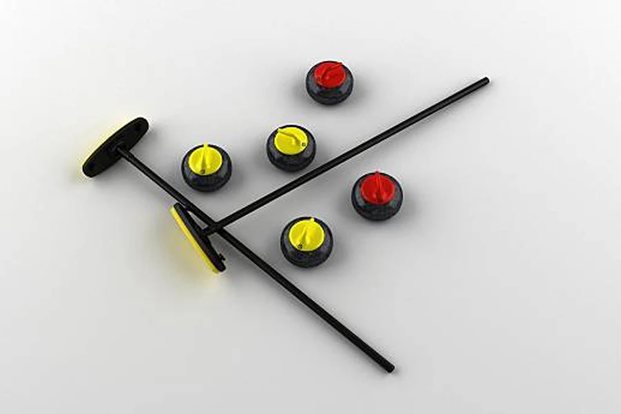Selection of curling stones and brooms placed on ice