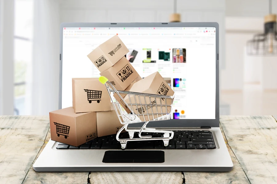 Shipping boxes and shopping cart on a laptop