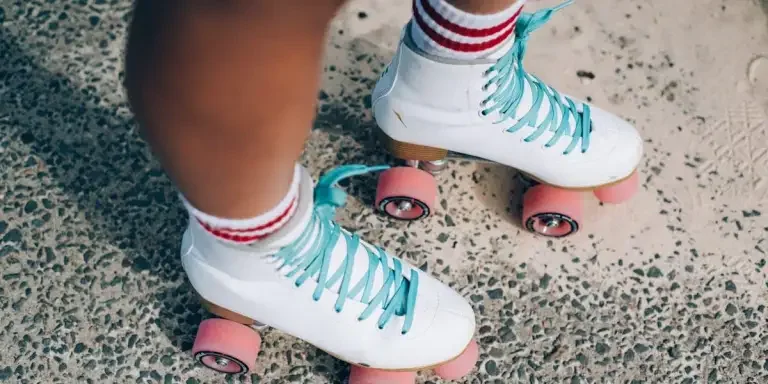 Skater standing in a pair of white roller skaters