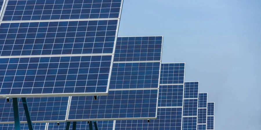 Solar cells panels at the solar farm on blue sky background