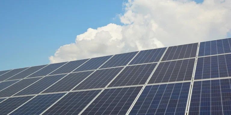 Solar panels against blue sky and white cloud with copy space