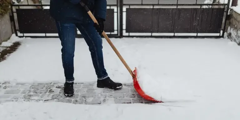 Someone shoveling snow with a snow shovel