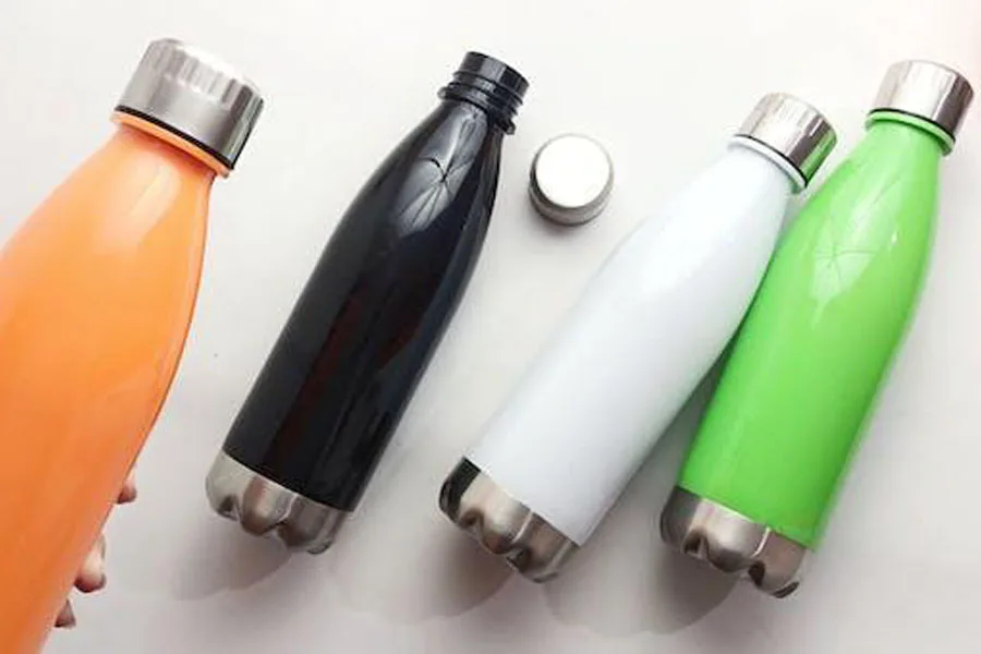 Stainless steel water bottles on white surface