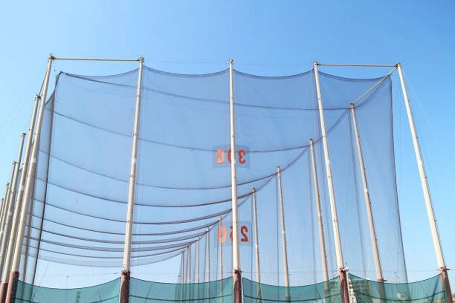 Tall golf hitting nets set up on driving range