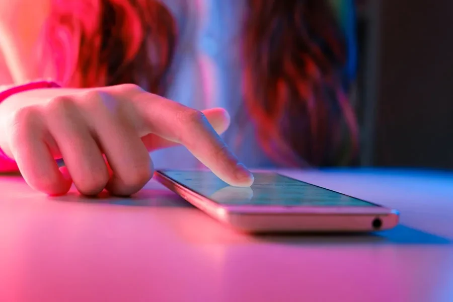 Teenager scrolling on her mobile phone