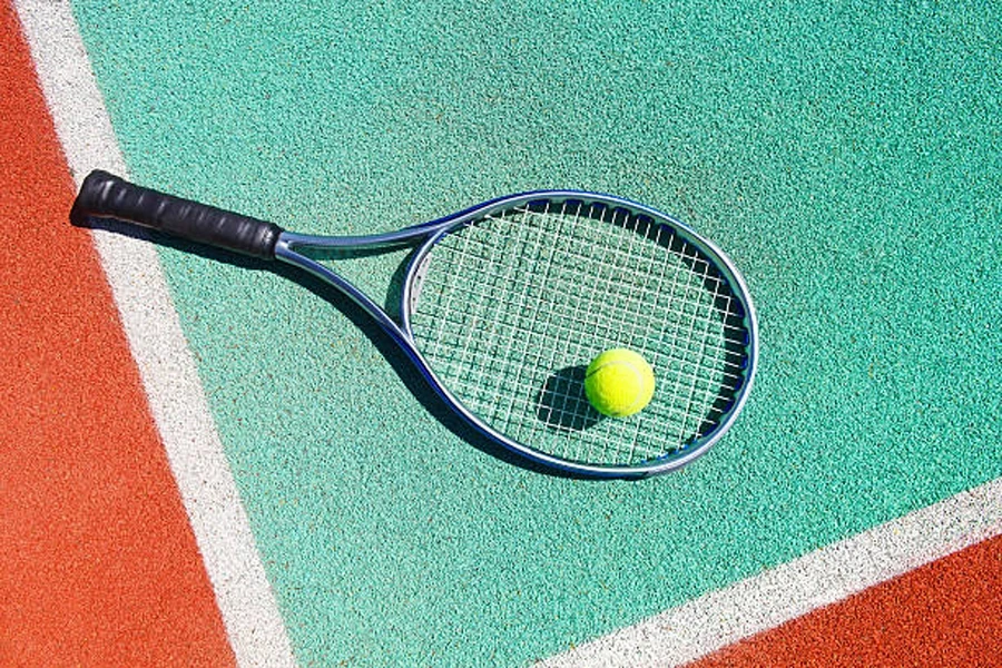 Tennis racquet with black replacement grip on court