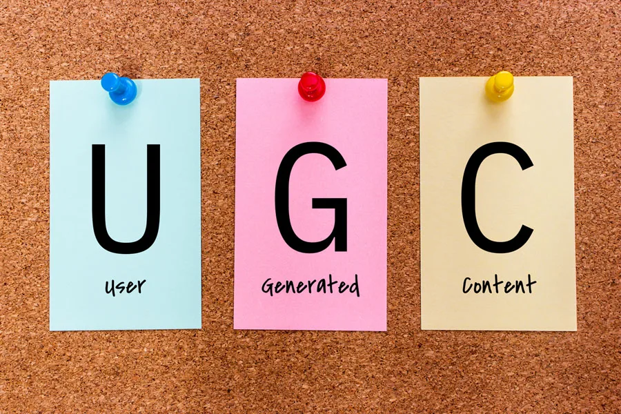 The letters “UGC” (user-generated content) on colored sticky notes