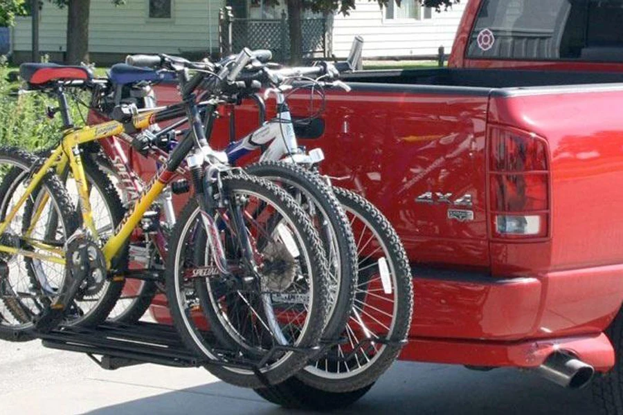 Three bicycles stored on a truck bike rack