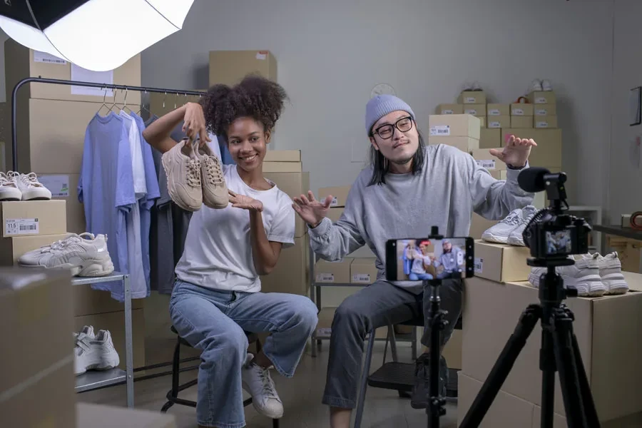 Two business owners showcasing shoes in a live stream