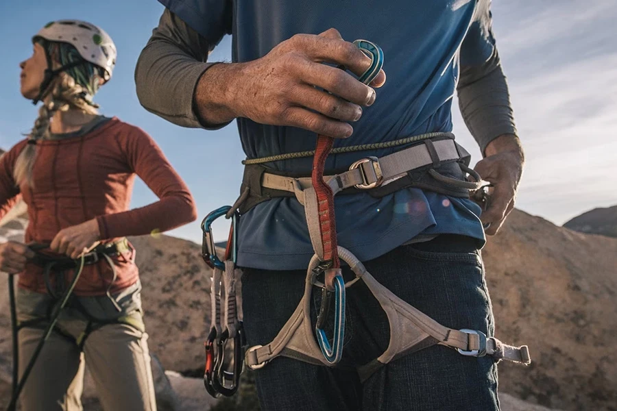 Two climbers wearing harnesses and other accessories