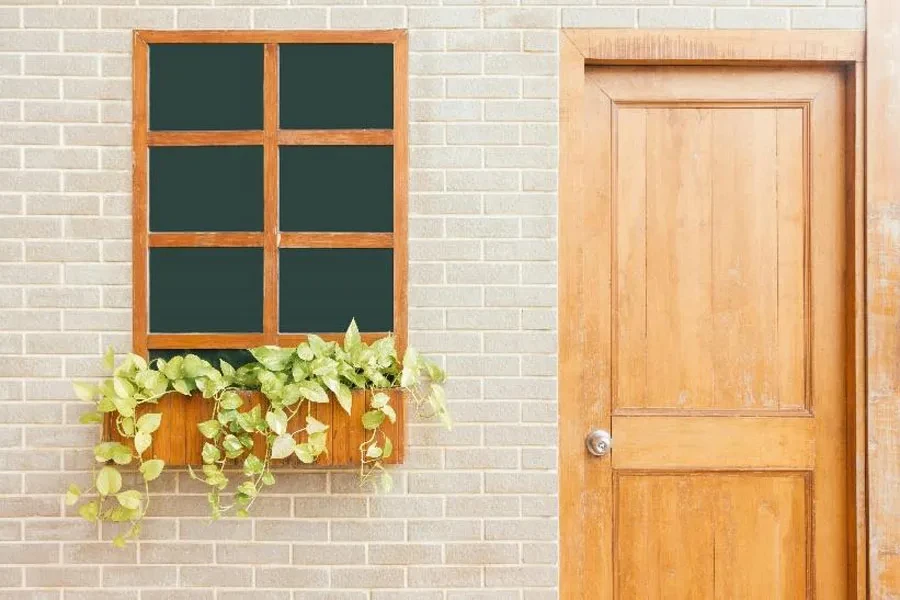 White brick building with light wood entrance door