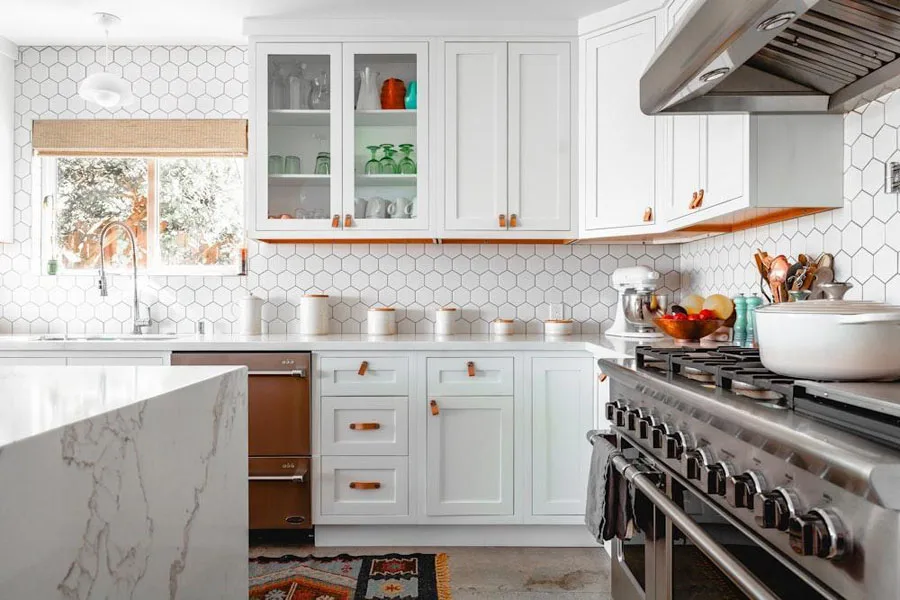 White kitchen cabinets with leather drawer pulls
