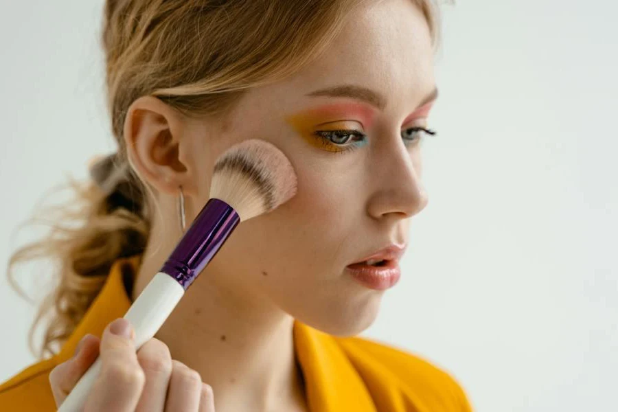 Woman applying blush on her cheeks