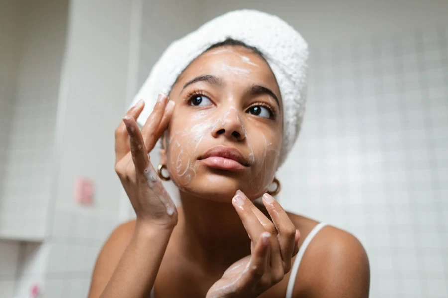 Woman applying cleanser in a bathroom