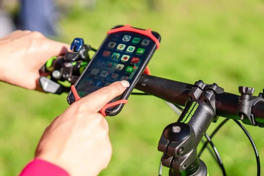 Woman checking her phone while it's attached to a phone holder