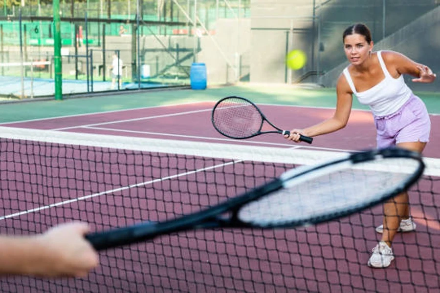 Woman performing tennis volley drill at the net