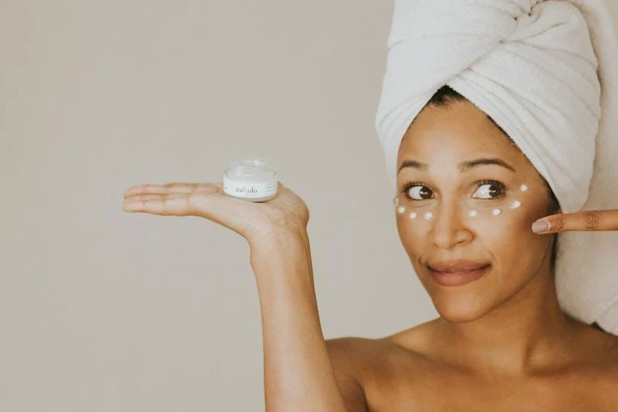 Woman preparing to use eye cream