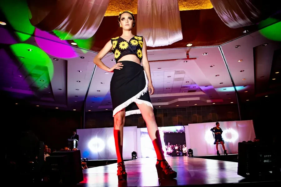 Woman standing on stage with hands on waist