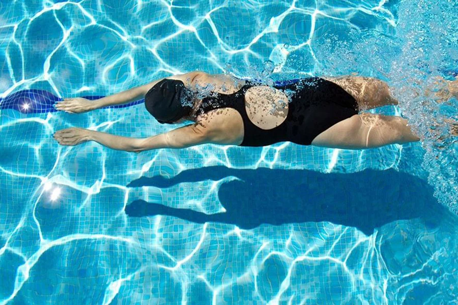 Woman swimming in a black one-piece swimsuit