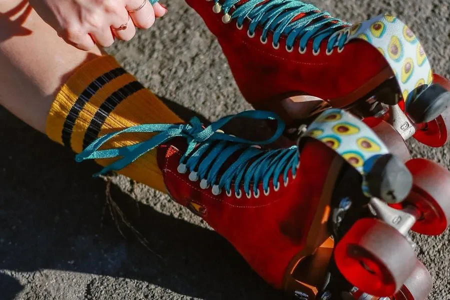 Woman with socks lacing fancy roller skates