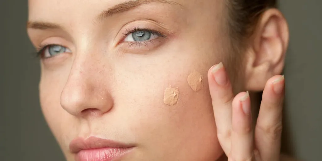 Woman with two drops of primer on her face