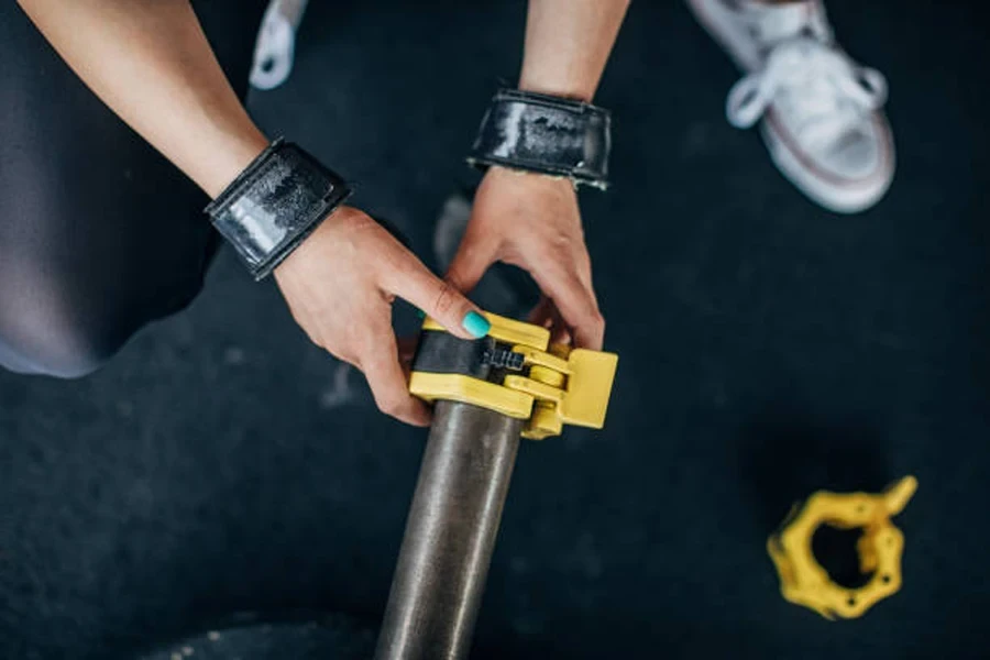 Yellow and black clamp collar being put on bar