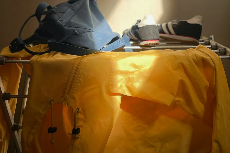 Yellow raincoat on metal clothes horse