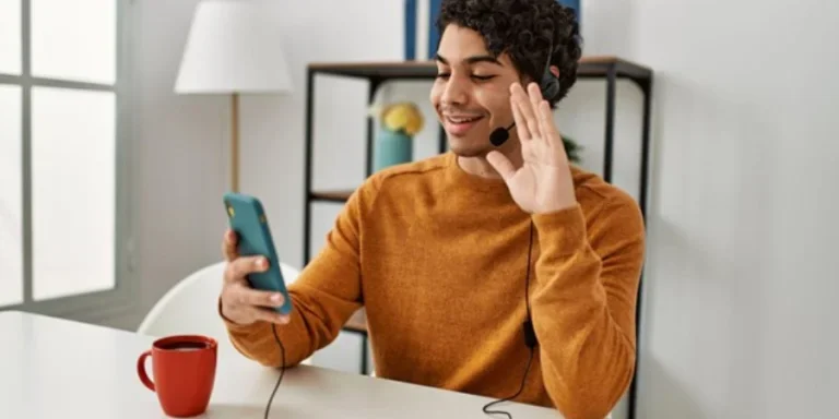 Young man having video call using Earphones at home