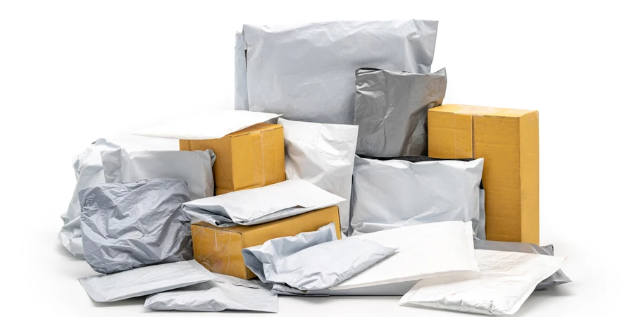 a Group of Postal Pack; plastic bag, paper envelope, brown paper box in studio light on the white background