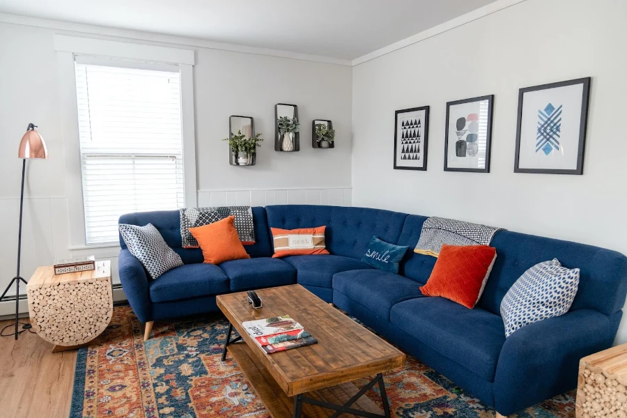 A blue couch with colored throw pillows