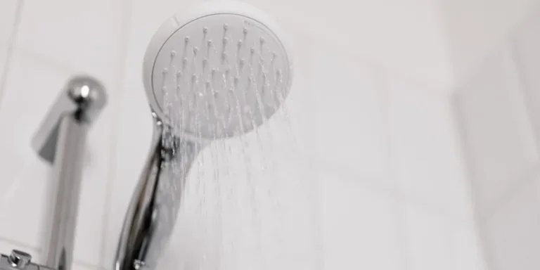 A showerhead turned on with water flowing