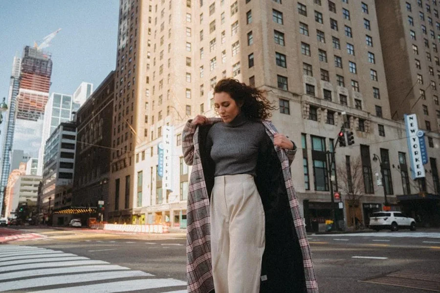 a woman wearing a long plaid jacket