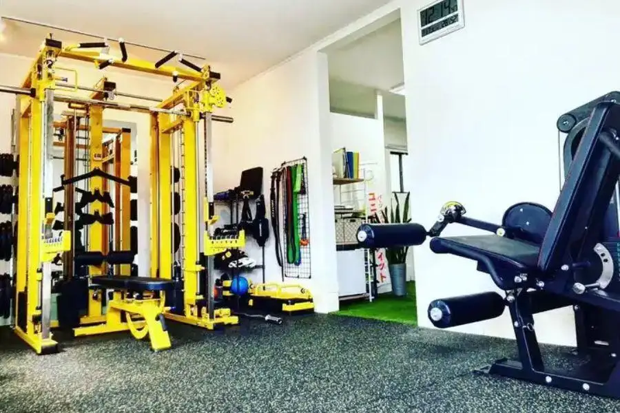 A yellow power rack in an exercise room