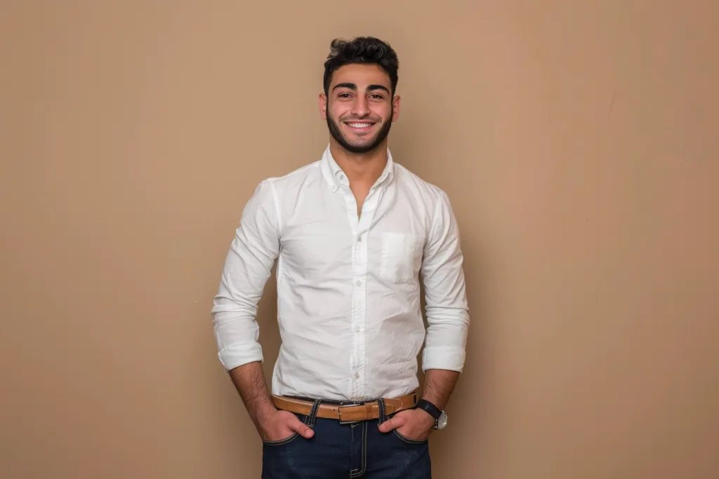 Photo of an attractive Middle Eastern man wearing a white long-sleeved button-up shirt