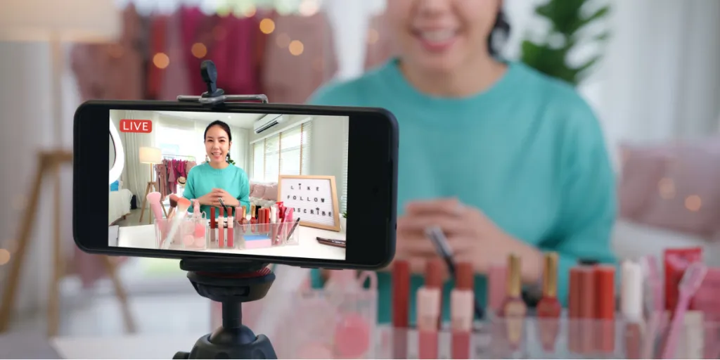 Asian woman streaming content with beauty products